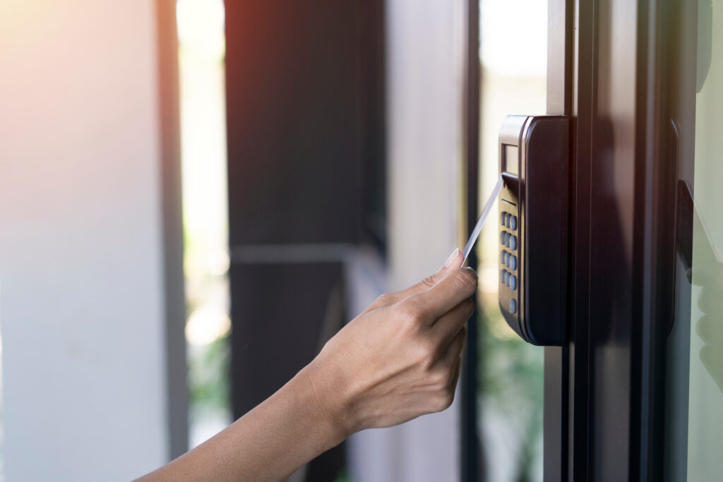 young woman using RFID tag key card, fingerprint and access cont